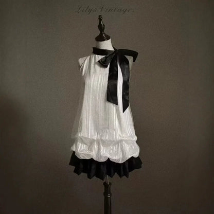 Vintage-Inspired Halter Babydoll Dress Bow Accent Flared Hem Classic Heiress Style Fit and Flare Dress