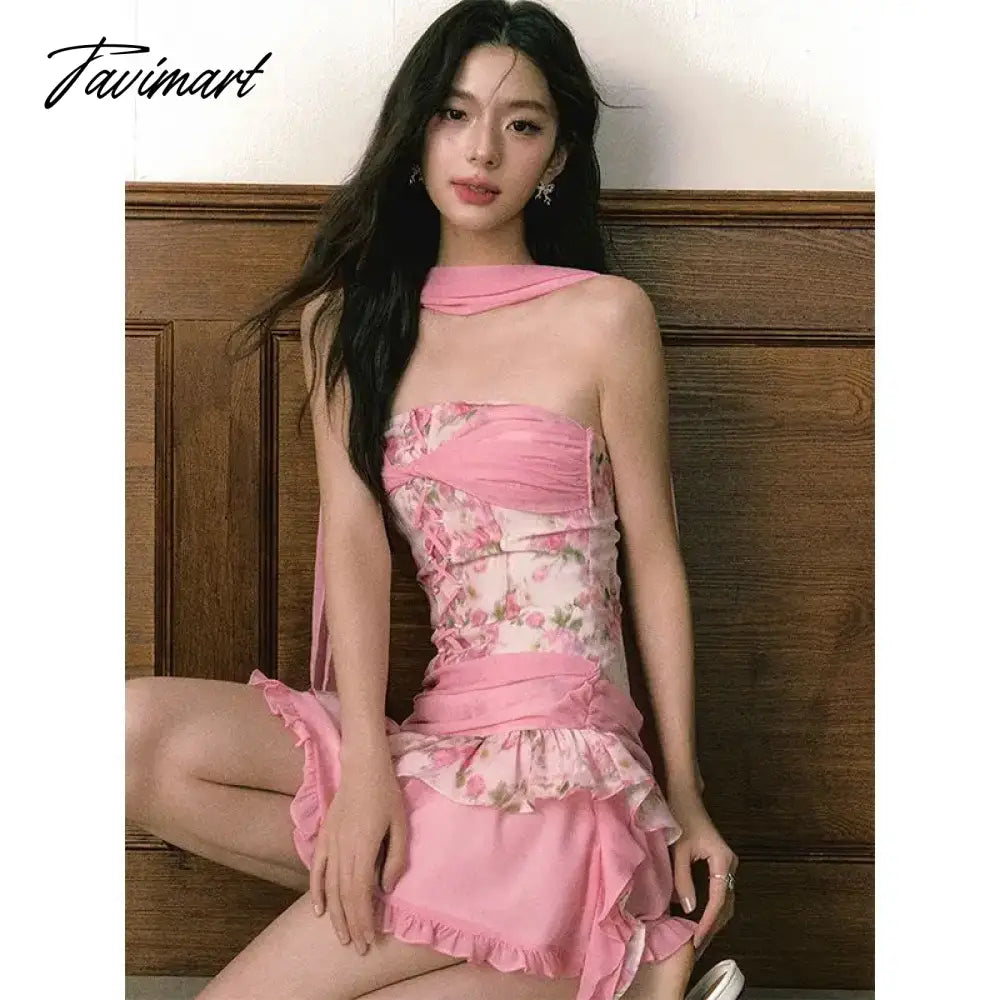 The women ensemble consists of a vibrant pink floral patchwork bustier dress, paired with a summery flutter skirt, creating 2024