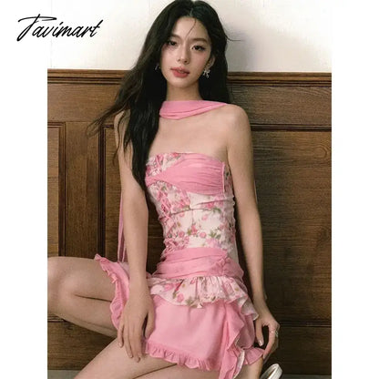 The women ensemble consists of a vibrant pink floral patchwork bustier dress, paired with a summery flutter skirt, creating 2024